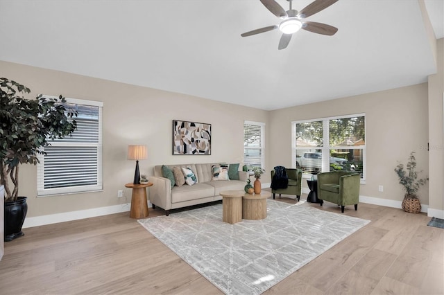 living room featuring ceiling fan and light wood-type flooring