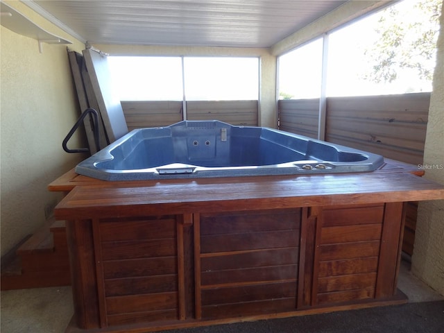 sunroom featuring a hot tub