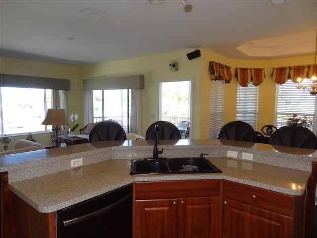 kitchen with dishwasher, sink, and a chandelier