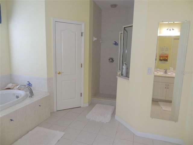 bathroom featuring plus walk in shower, vanity, and tile patterned flooring