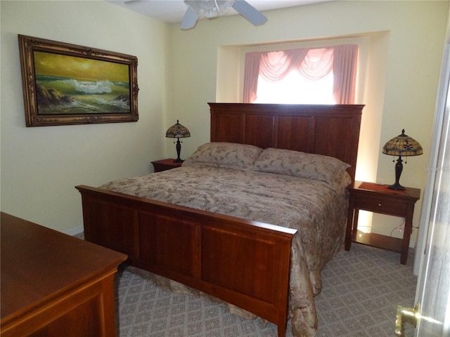 bedroom featuring ceiling fan and light carpet