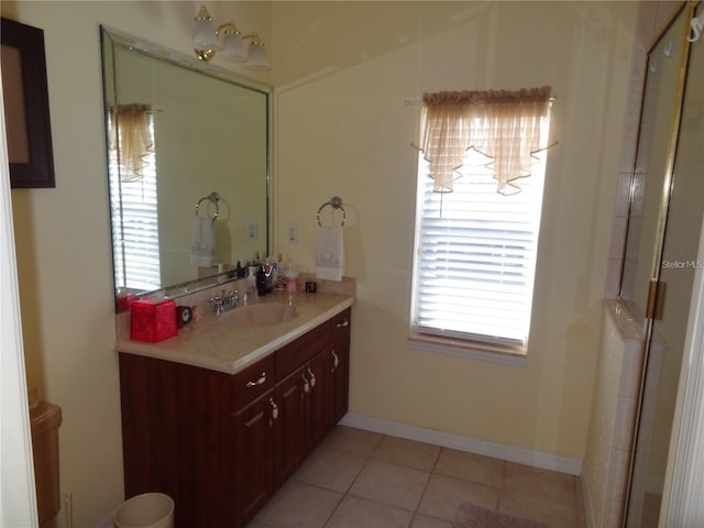 bathroom with tile patterned floors, vanity, an enclosed shower, and a wealth of natural light