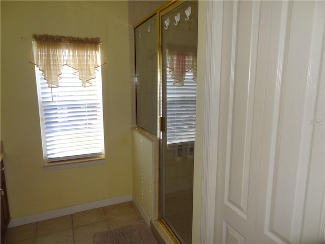 bathroom with tile patterned floors, vanity, and an enclosed shower