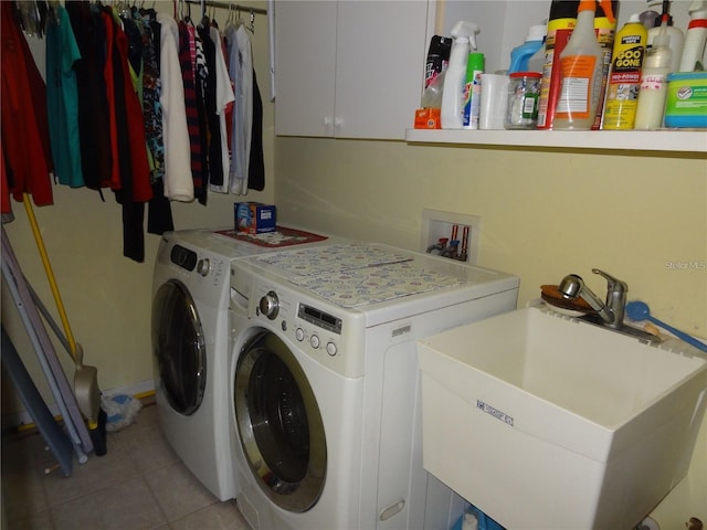 clothes washing area with cabinets, sink, separate washer and dryer, and light tile patterned flooring