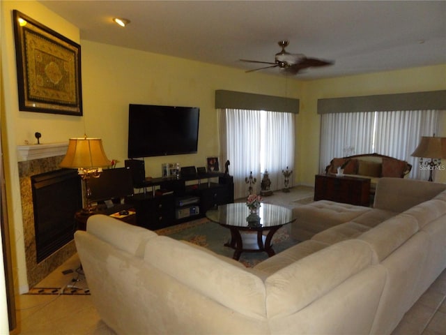 living room featuring ceiling fan, light tile patterned flooring, and a premium fireplace