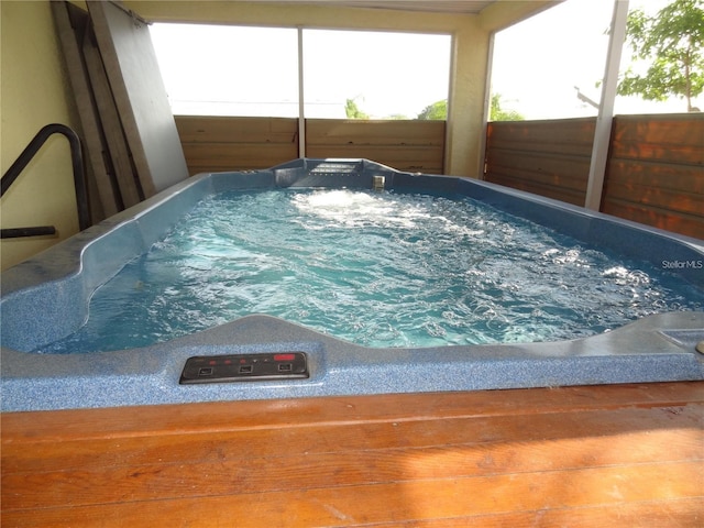 view of pool with a hot tub