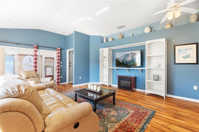 living room featuring ceiling fan, built in features, wood-type flooring, and lofted ceiling