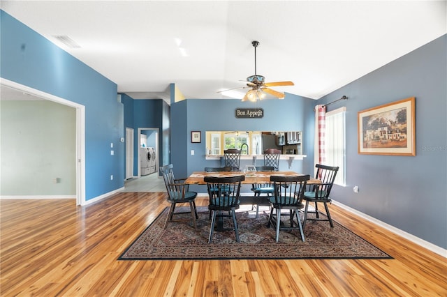 dining space featuring hardwood / wood-style floors, ceiling fan, and lofted ceiling