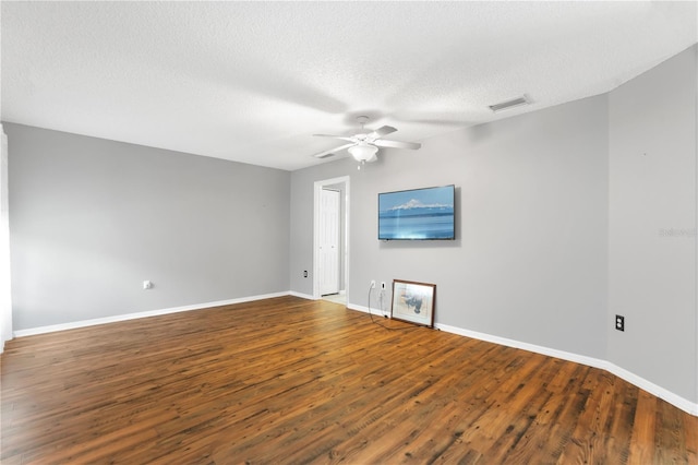 unfurnished room with ceiling fan, dark hardwood / wood-style flooring, and a textured ceiling