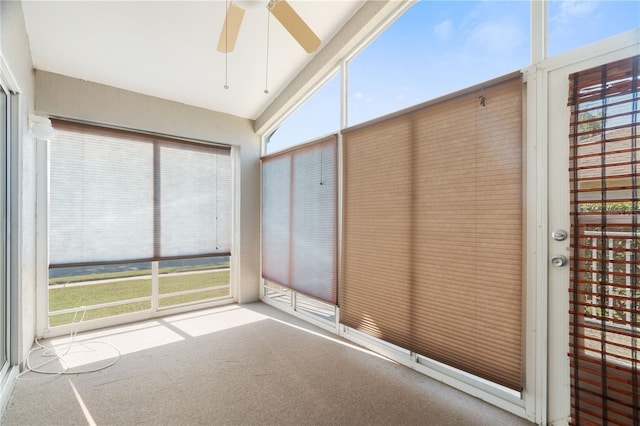 unfurnished sunroom featuring ceiling fan and vaulted ceiling