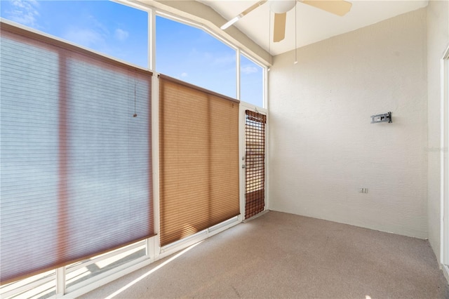 unfurnished sunroom featuring ceiling fan