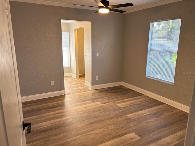 spare room featuring crown molding, hardwood / wood-style floors, and ceiling fan