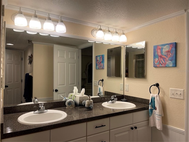 bathroom with ornamental molding, a textured ceiling, and vanity