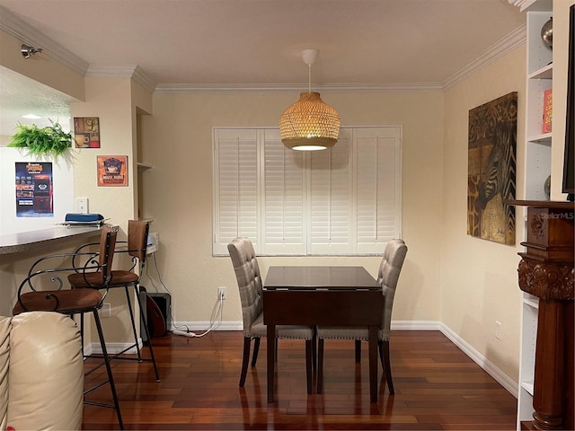 dining room featuring ornamental molding and dark hardwood / wood-style floors