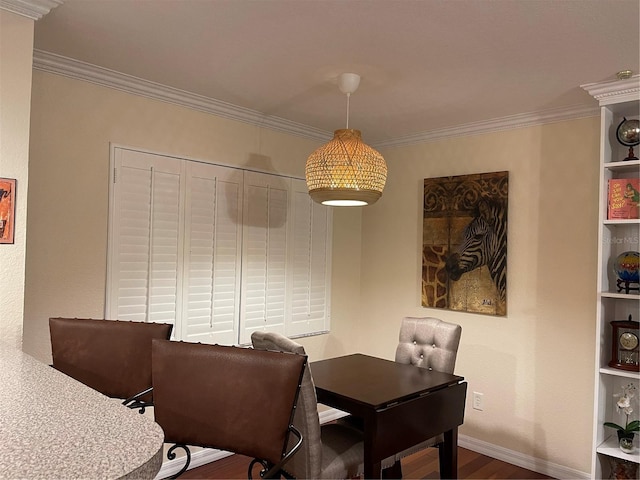 dining space featuring crown molding and wood-type flooring