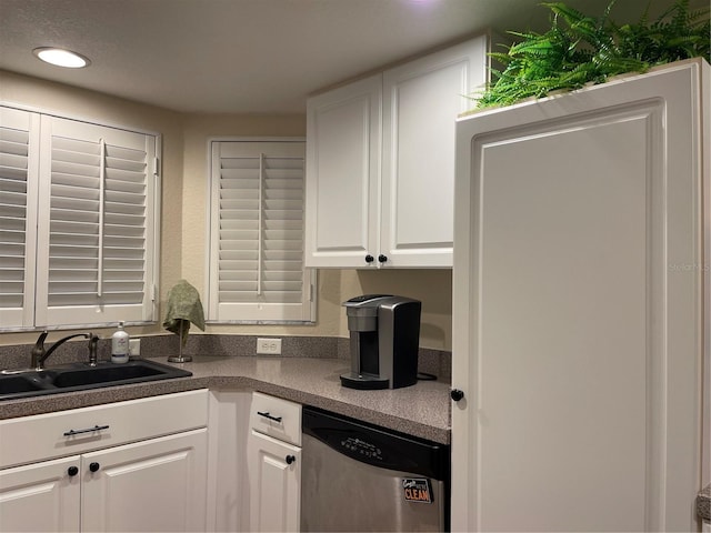 kitchen with white cabinetry, sink, and stainless steel dishwasher