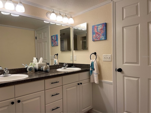 bathroom with vanity, crown molding, and a textured ceiling