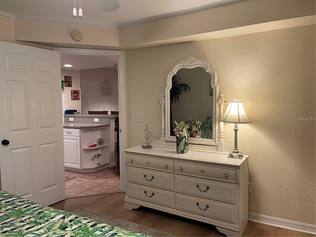 bedroom featuring dark wood-type flooring, ceiling fan, and ornamental molding