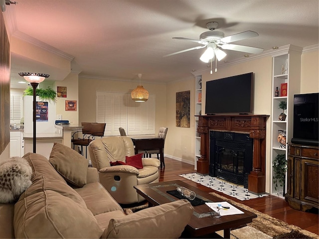 living room with crown molding, ceiling fan, and dark hardwood / wood-style floors