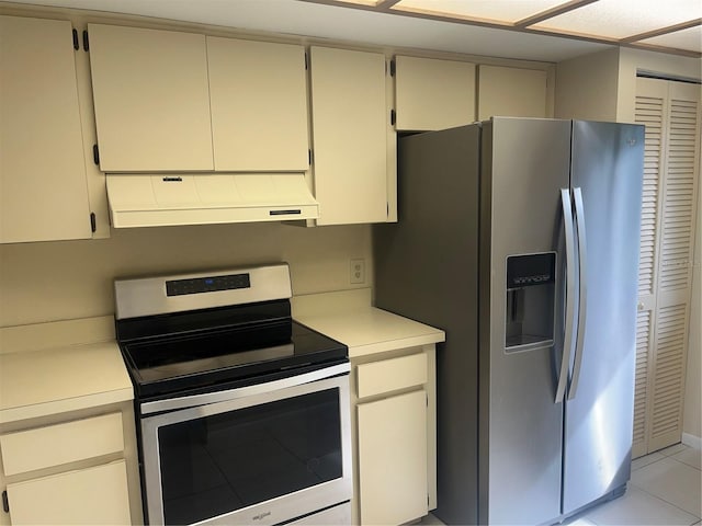 kitchen featuring appliances with stainless steel finishes, light tile patterned floors, and exhaust hood