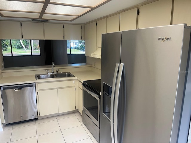 kitchen with light tile patterned floors, sink, and appliances with stainless steel finishes