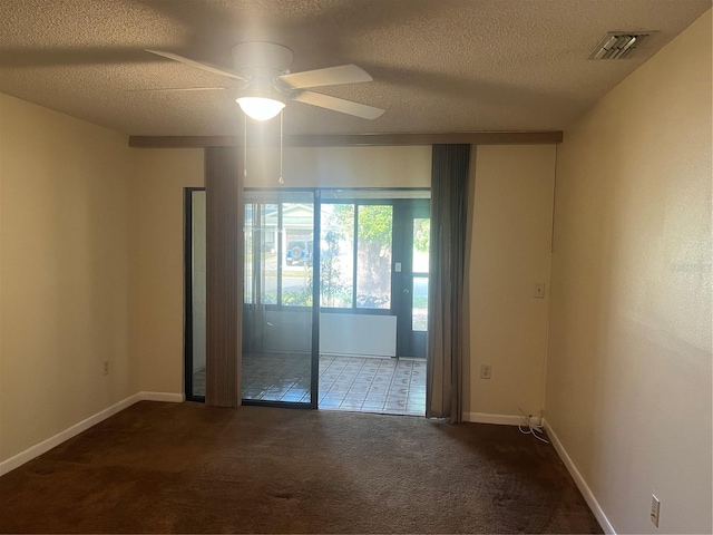 carpeted empty room with ceiling fan and a textured ceiling