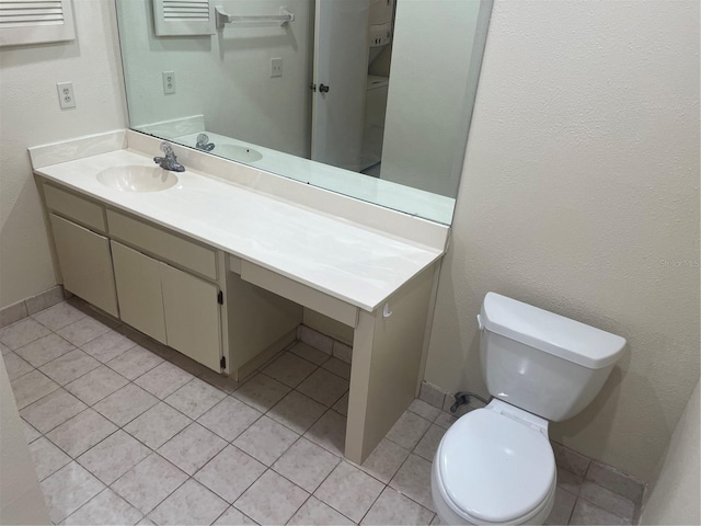 bathroom featuring tile patterned floors, vanity, and toilet