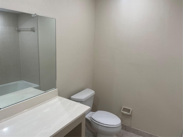 bathroom featuring tile patterned flooring, vanity, and toilet