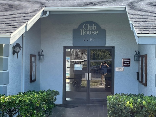 view of exterior entry featuring french doors