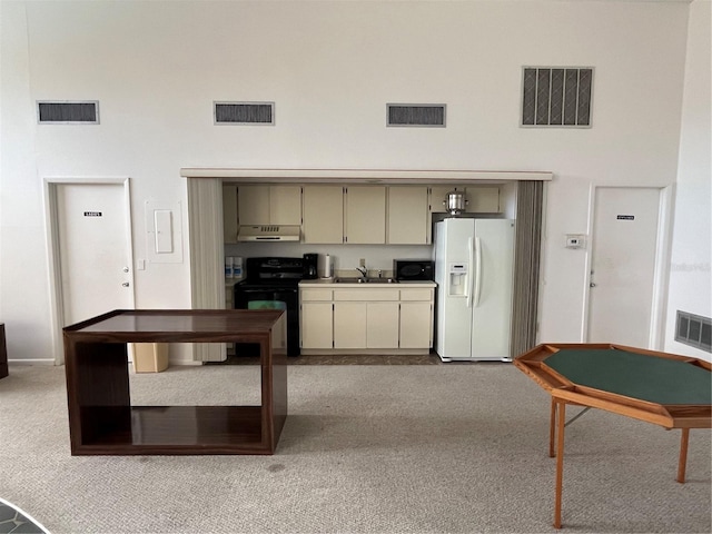 kitchen with light carpet, black electric range, sink, white refrigerator with ice dispenser, and cream cabinetry