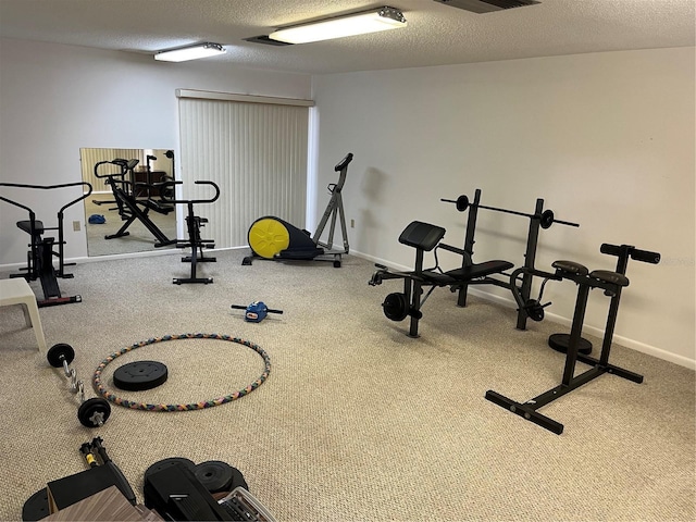 workout area featuring a textured ceiling