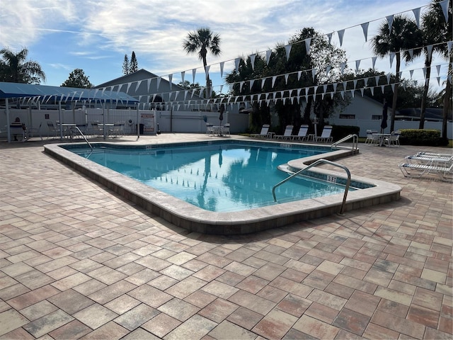 view of swimming pool featuring a patio area