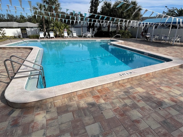 view of swimming pool with a patio