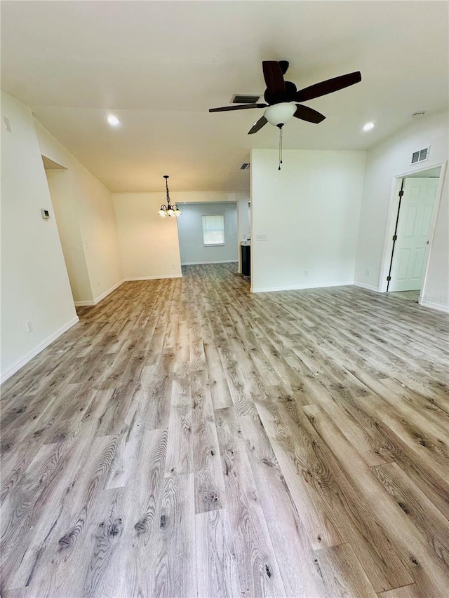 unfurnished living room featuring ceiling fan and light hardwood / wood-style floors