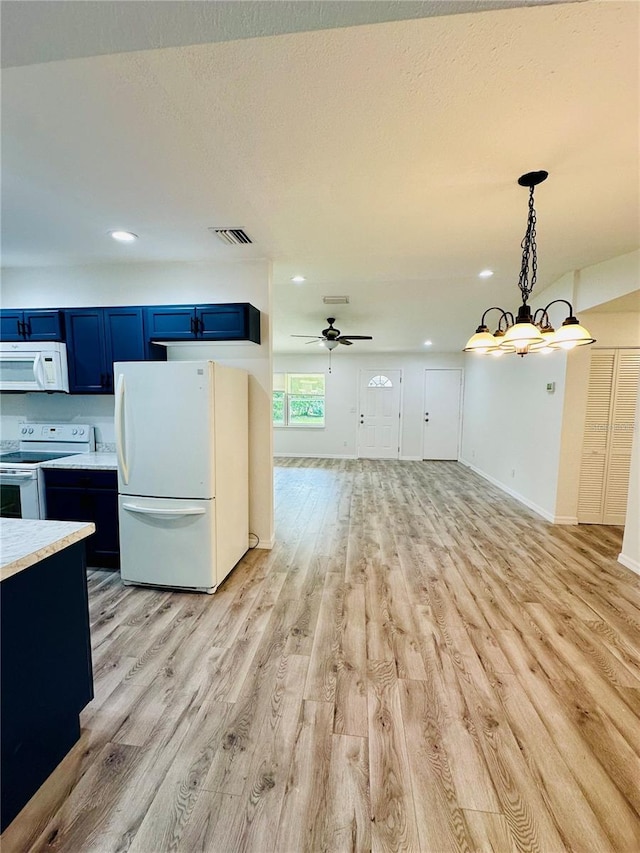 kitchen featuring blue cabinetry, hanging light fixtures, white appliances, ceiling fan with notable chandelier, and light wood-type flooring