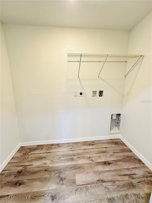 laundry area featuring electric dryer hookup, hookup for a washing machine, and hardwood / wood-style flooring