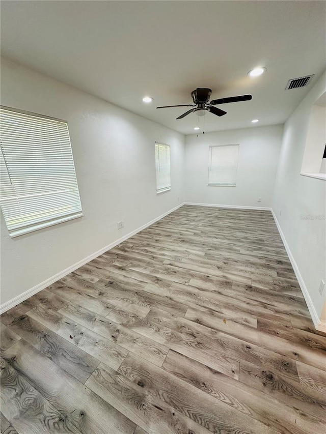 spare room with hardwood / wood-style flooring and ceiling fan