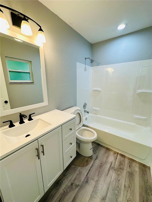 full bathroom featuring hardwood / wood-style flooring, vanity, toilet, and shower / bath combination