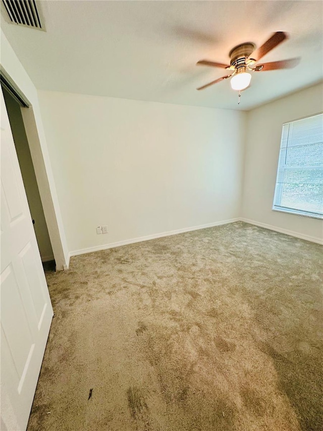 unfurnished room featuring carpet flooring and ceiling fan