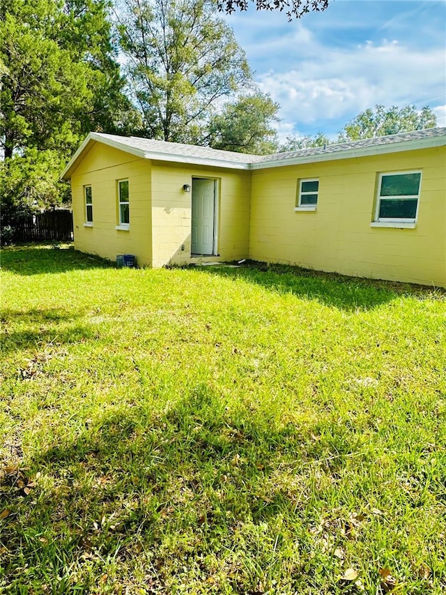 back of house featuring a yard