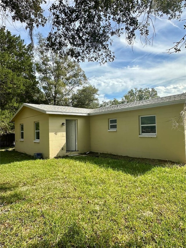 rear view of house with a lawn