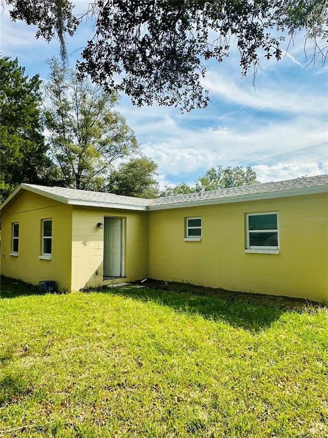 back of house with a lawn