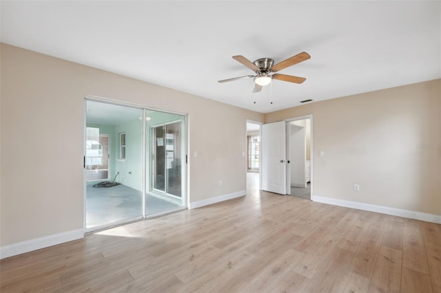 spare room with light wood-type flooring, plenty of natural light, and ceiling fan