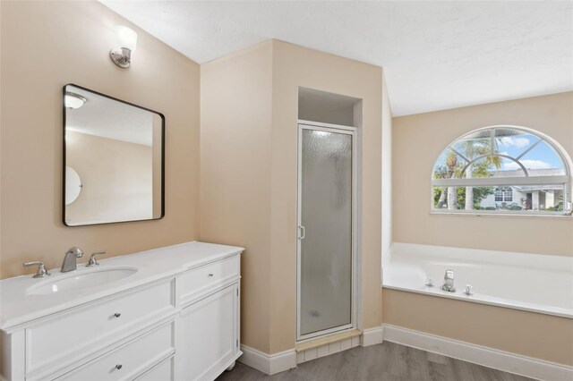 bathroom featuring vanity, independent shower and bath, and hardwood / wood-style flooring