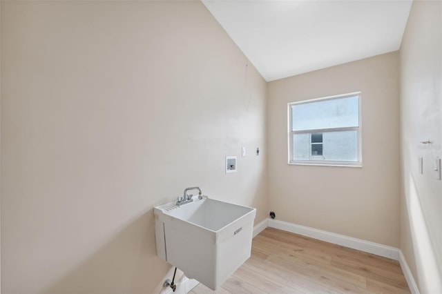 laundry room featuring hookup for a washing machine, light hardwood / wood-style flooring, and sink