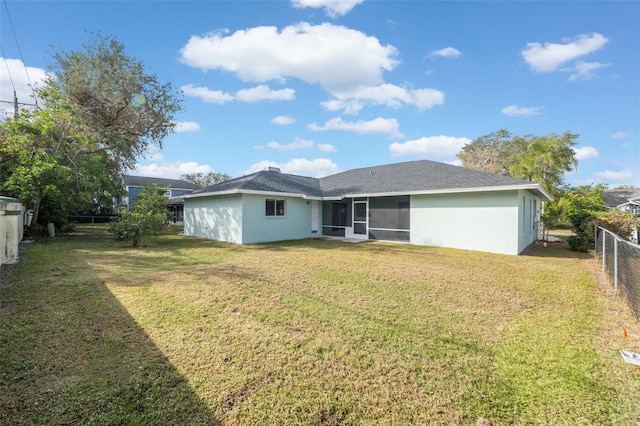 rear view of property with a yard