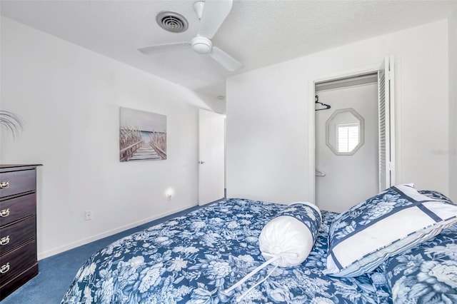 carpeted bedroom featuring a textured ceiling and ceiling fan