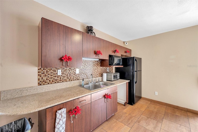 kitchen with black appliances, sink, backsplash, and a textured ceiling