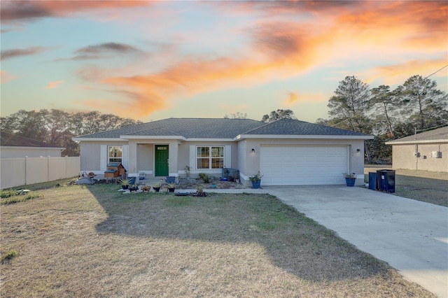 view of front of property featuring a yard and a garage