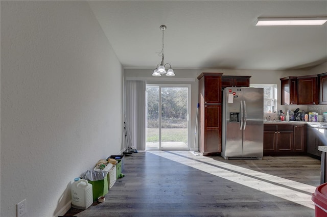 kitchen featuring a notable chandelier, light hardwood / wood-style floors, stainless steel fridge with ice dispenser, and decorative light fixtures